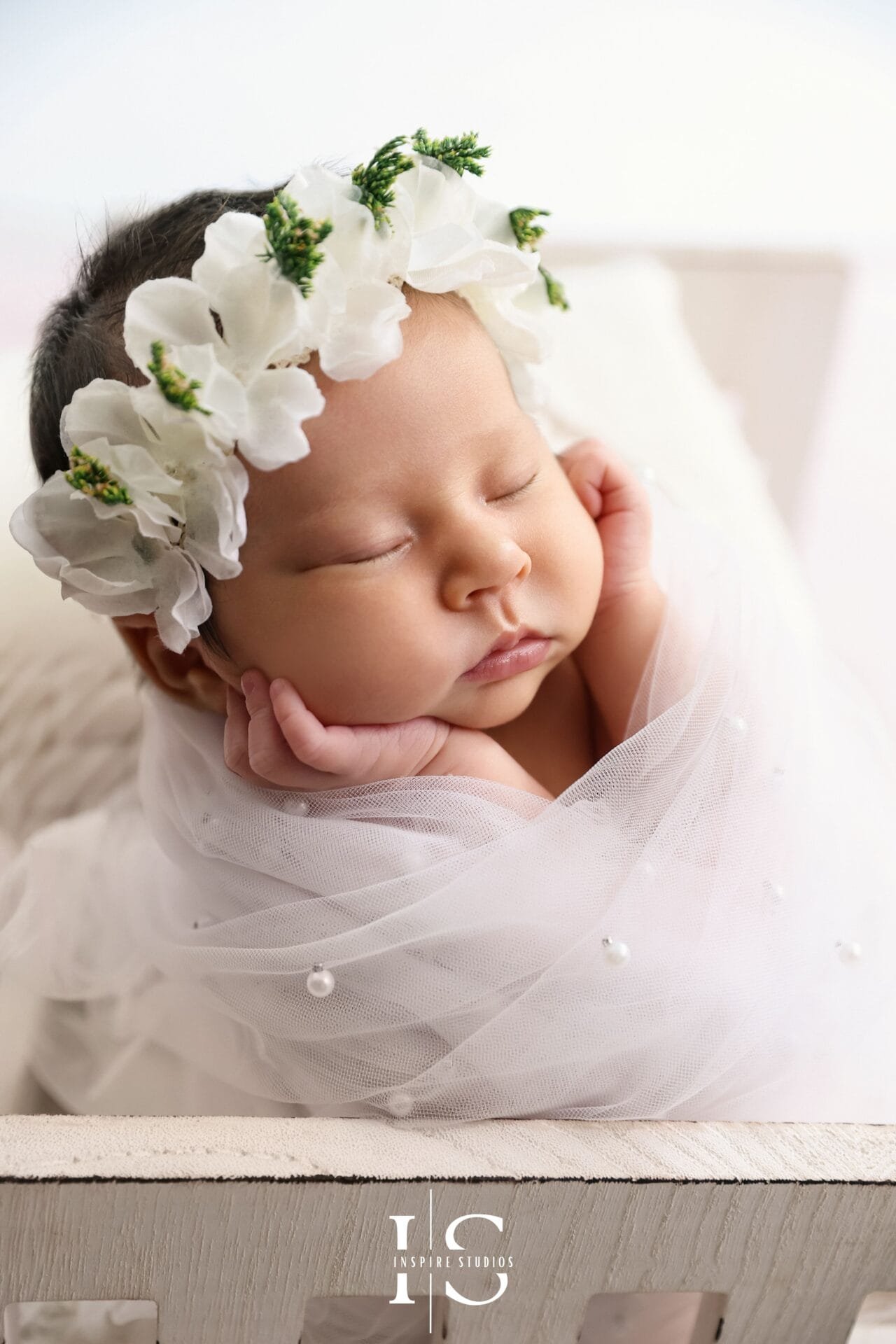 Newborn photoshoot posing ideas at Inspire Studios in London with a baby safely posed in a studio setup.