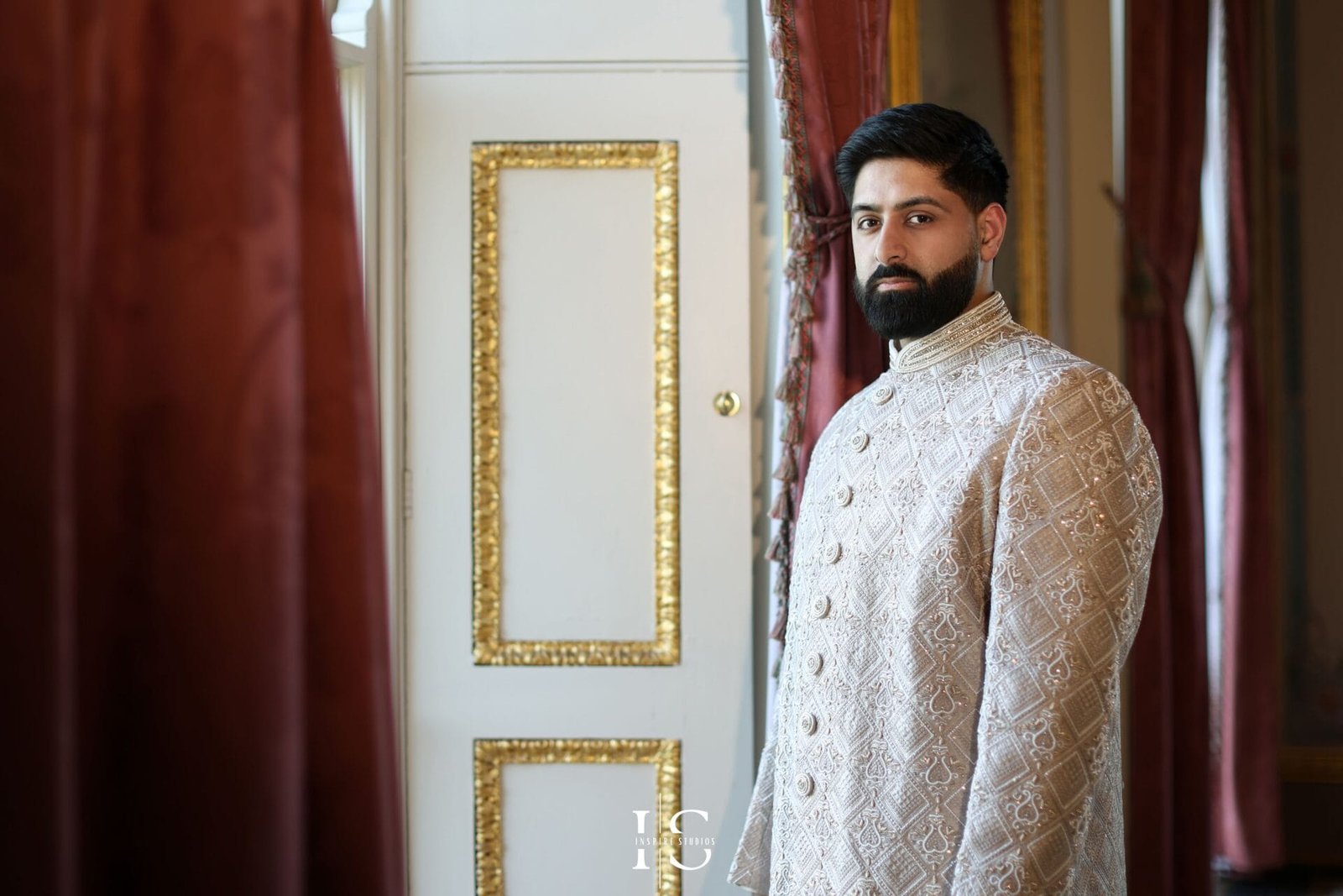 Groom in Pakistani wedding attire posing at Hylands House in Chelmsford.