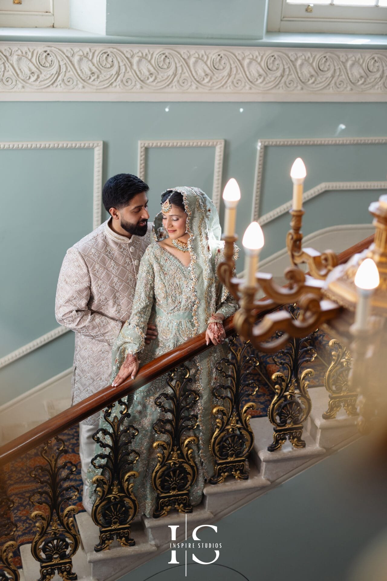 Pakistani wedding couple posing on the Grand Staircase at Hylands House.