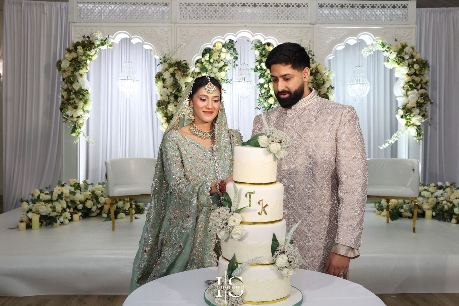 Bride and groom cutting their wedding cake at Hylands House in Chelmsford.