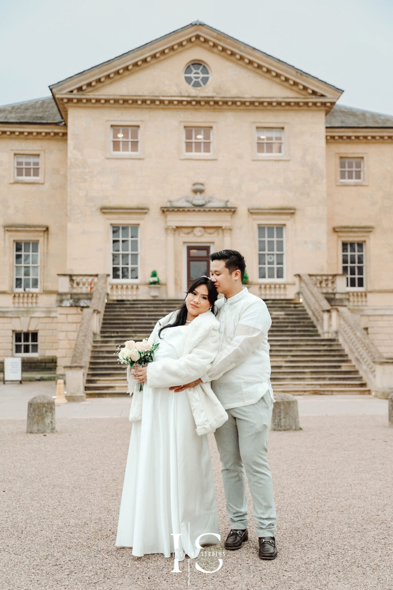 Filipino bride and groom posing together for wedding portraits outside Danson House in Bexley.