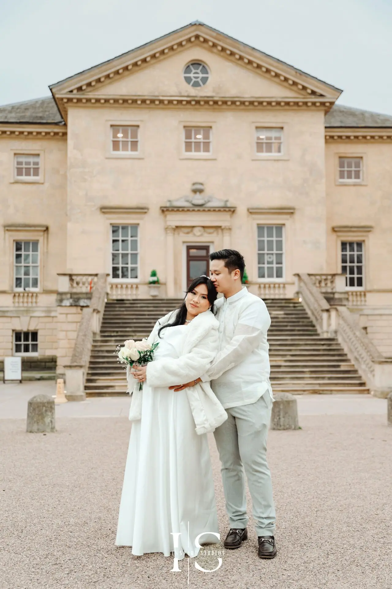 Filipino bride and groom posing together for wedding portraits outside Danson House in Bexley.