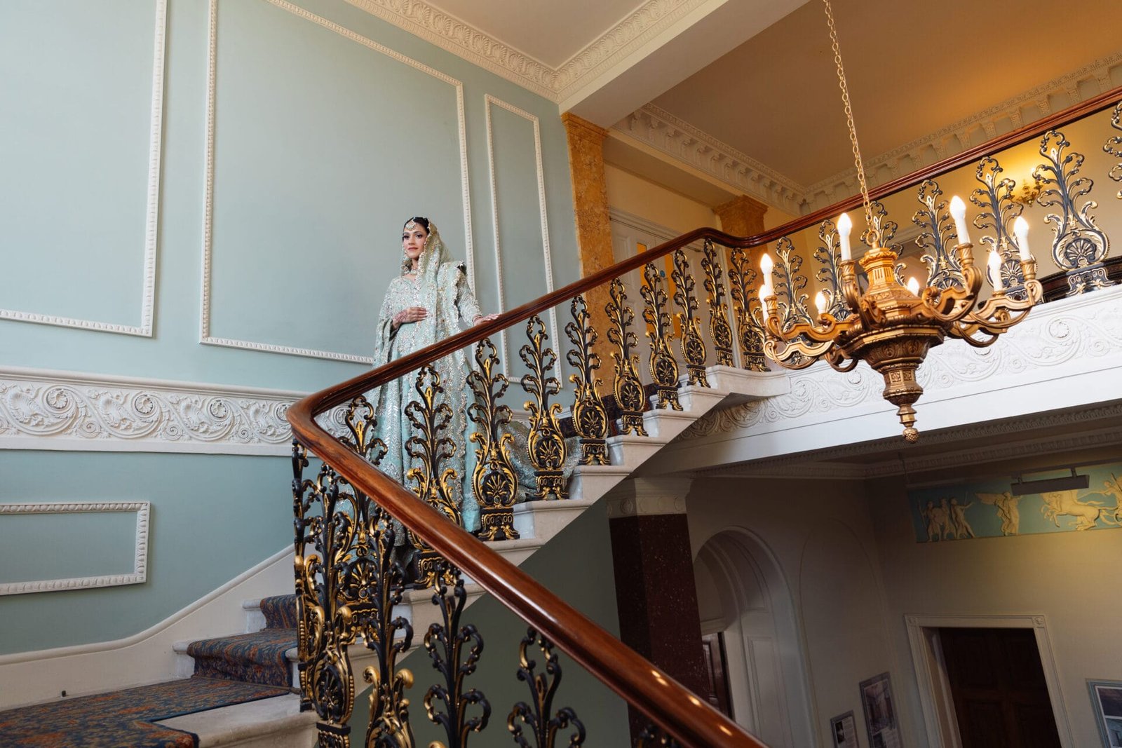 Bride posing for a wedding portrait inside Hylands House in Chelmsford, Essex.