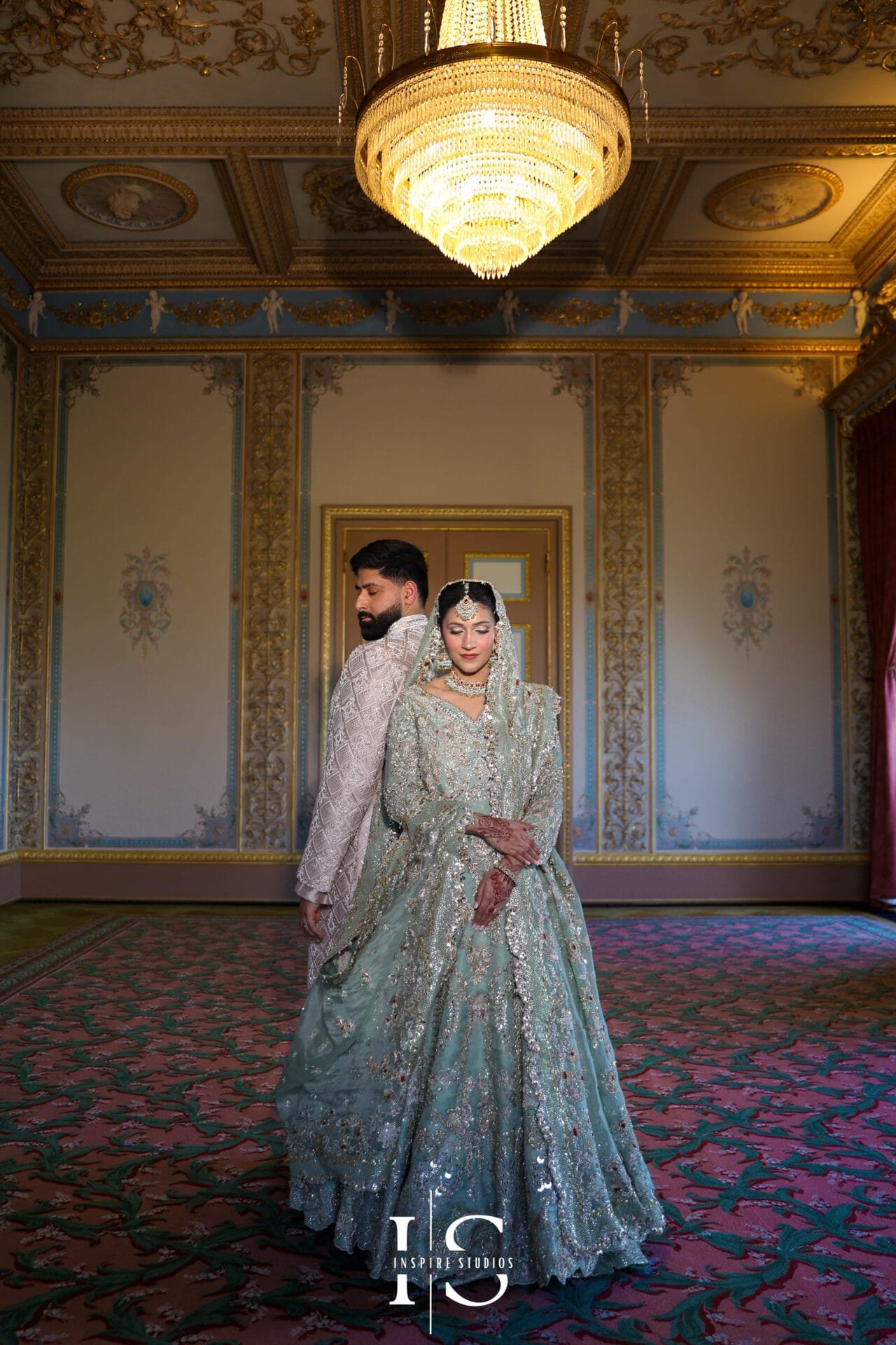 Bride and groom posing for a couple portrait at Hylands House in Chelmsford.