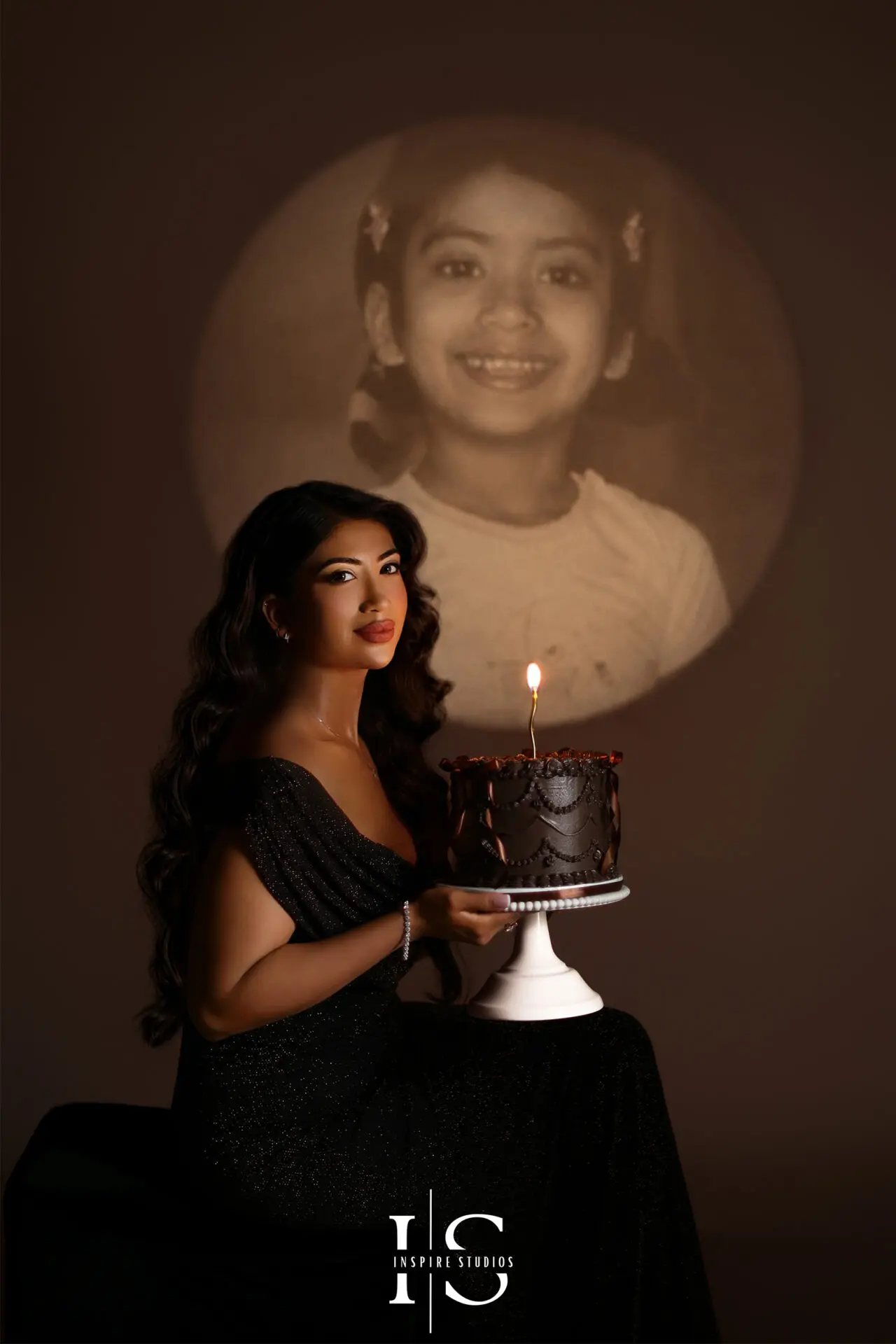 Spotlight projection birthday photoshoot with childhood picture displayed behind the birthday portrait in a London studio.