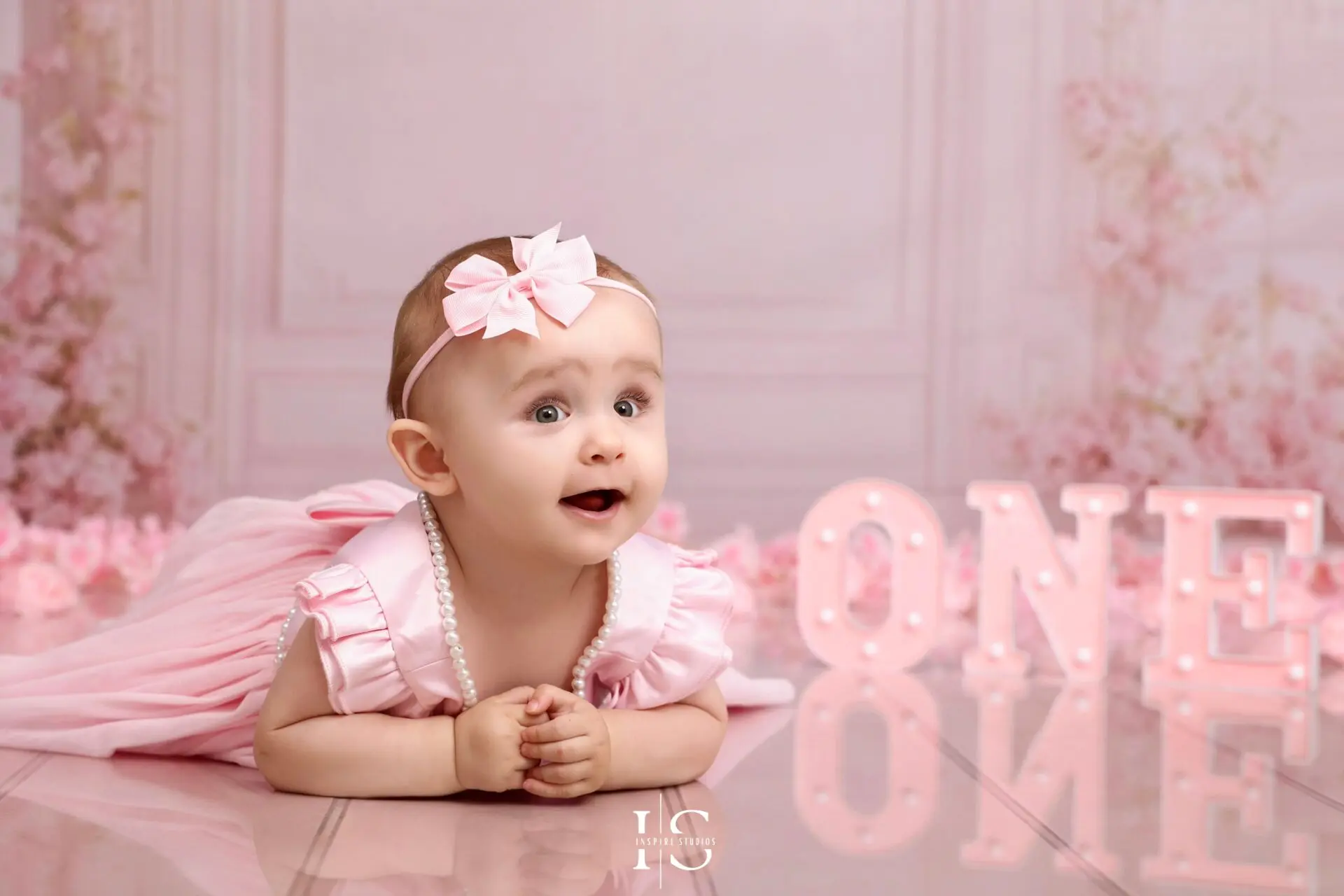 One-year-old baby girl posing for a studio portrait at Inspire Studios in Walthamstow, East London.