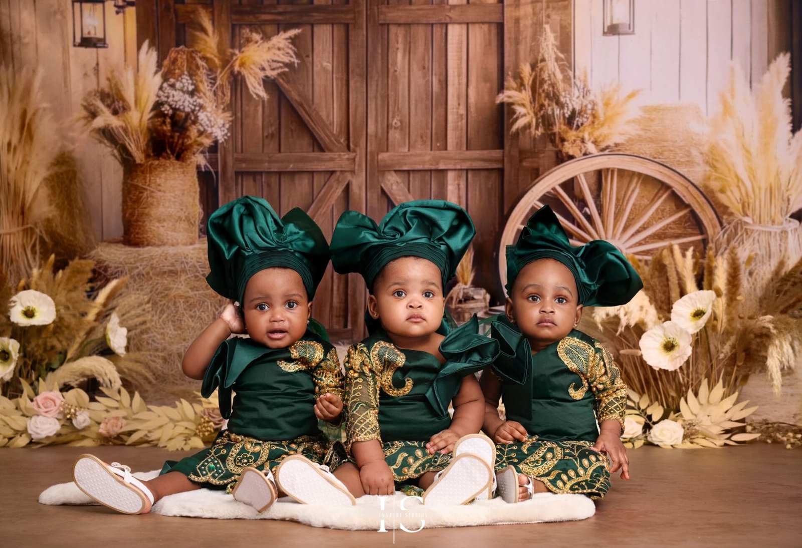 One-year-old triplets wearing traditional African outfits during a boho birthday photoshoot in London.