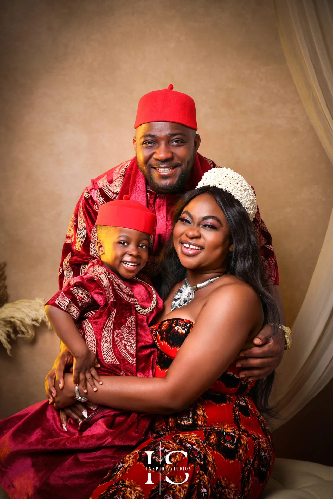 Family wearing African traditional outfits during a studio photoshoot in East London.