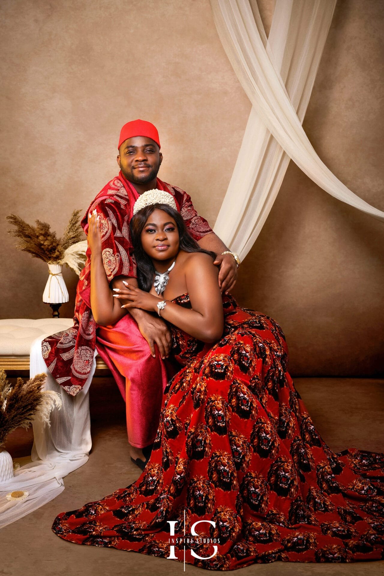 Couple wearing African traditional outfits during a studio photoshoot in East London.