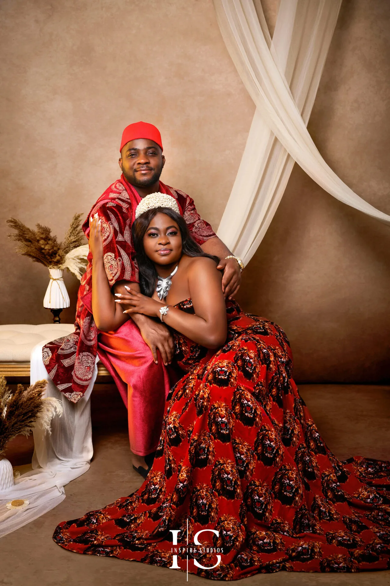 Couple wearing African traditional outfits during a studio photoshoot in East London.